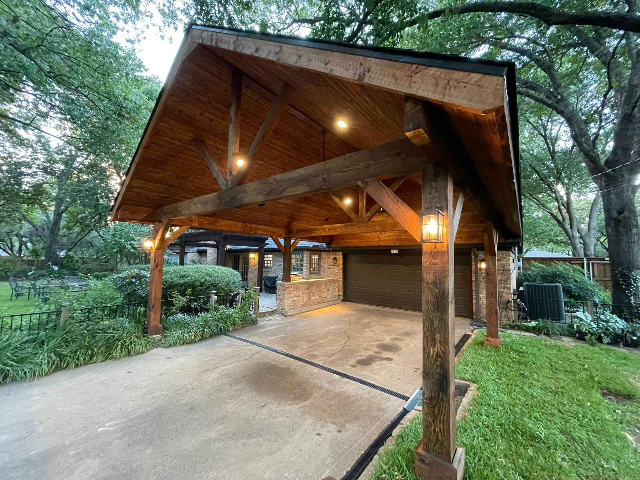 Timber-frame carport at dusk with warm lighting