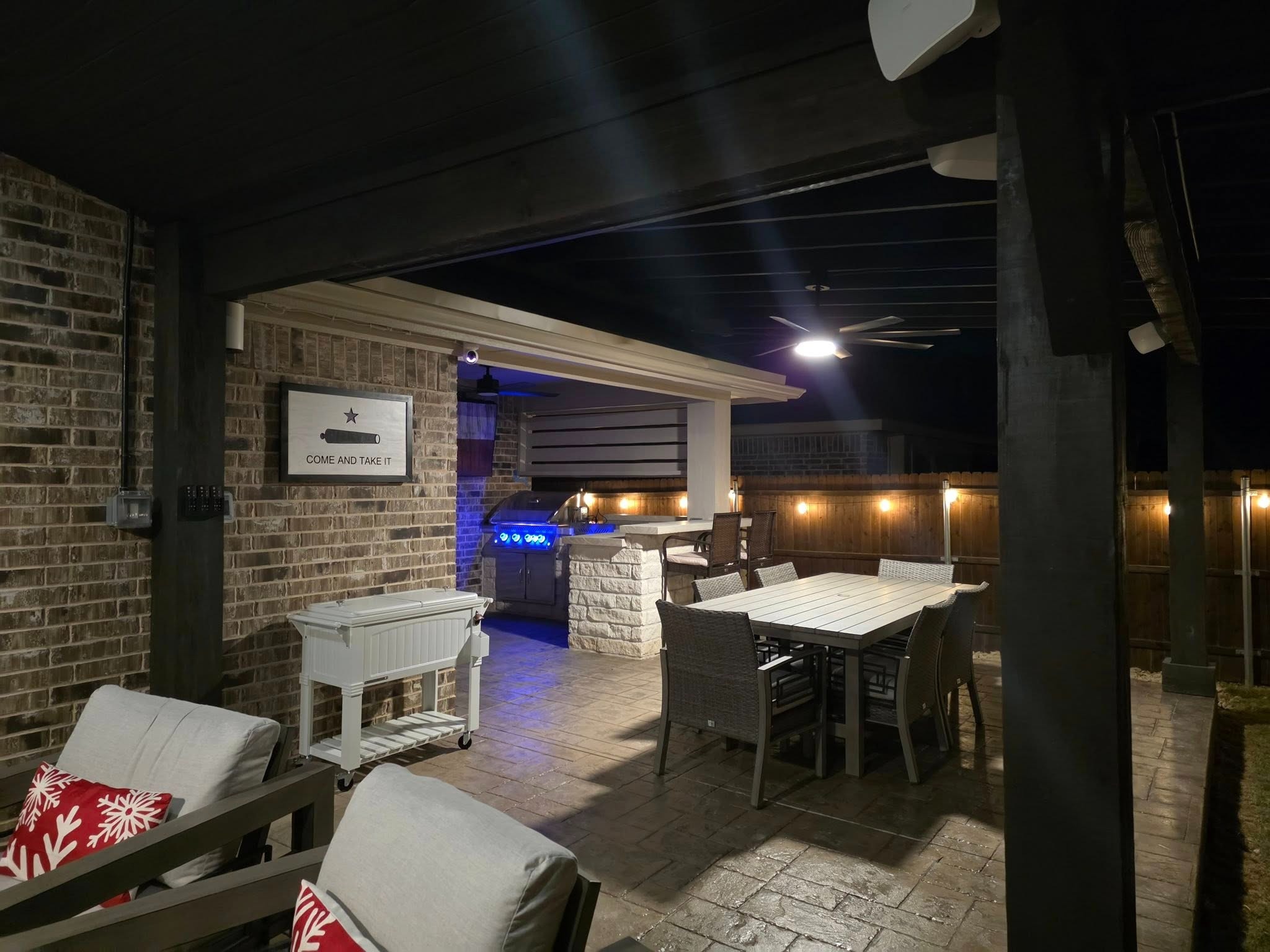Outdoor kitchen and dining area at night
