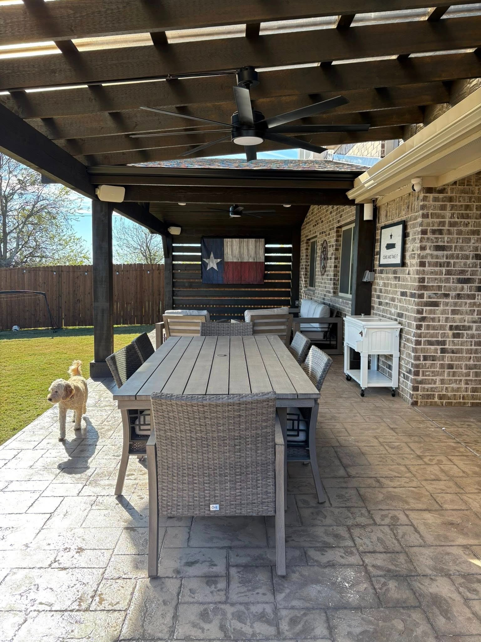 Dining area under pergola with dog