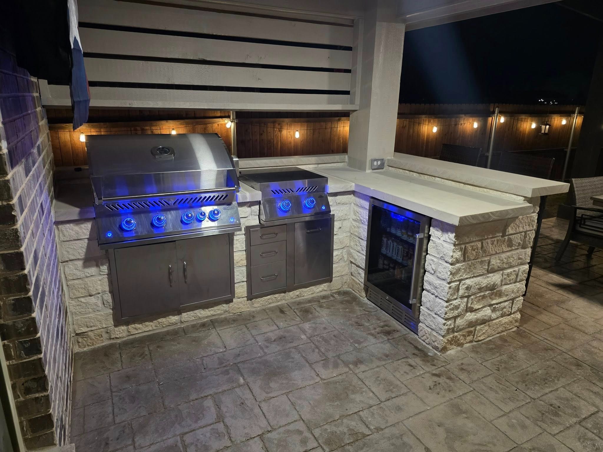 Outdoor kitchen grill at night with blue LED