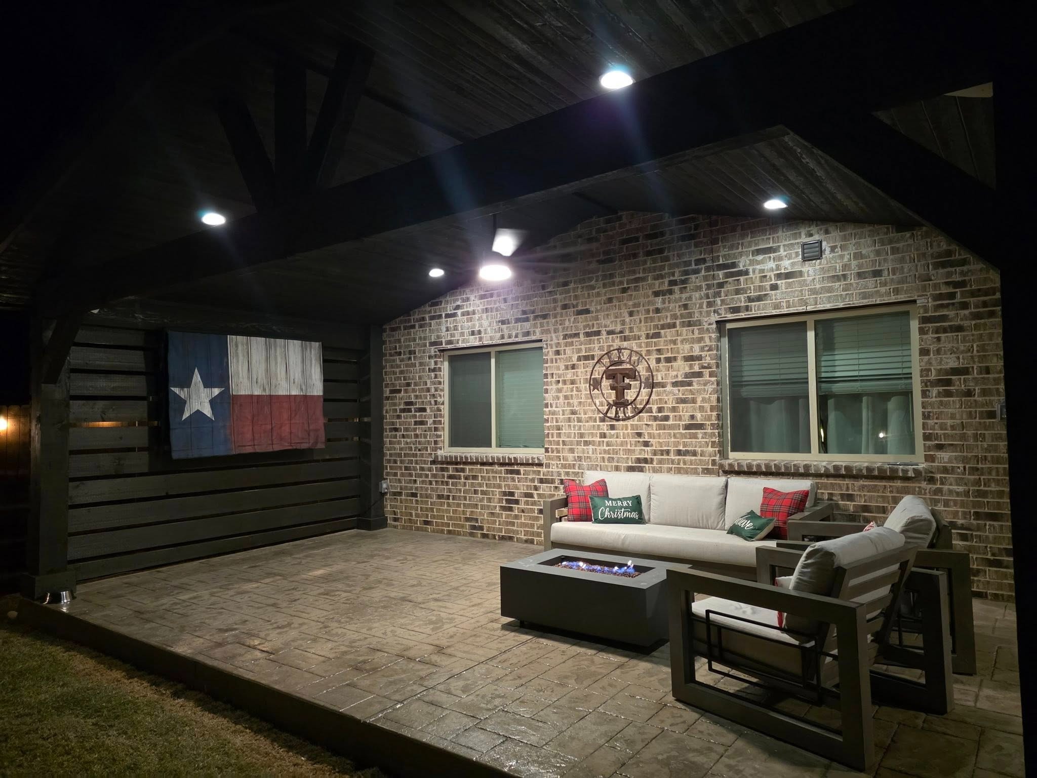 Lounge area with fire pit and Texas flag