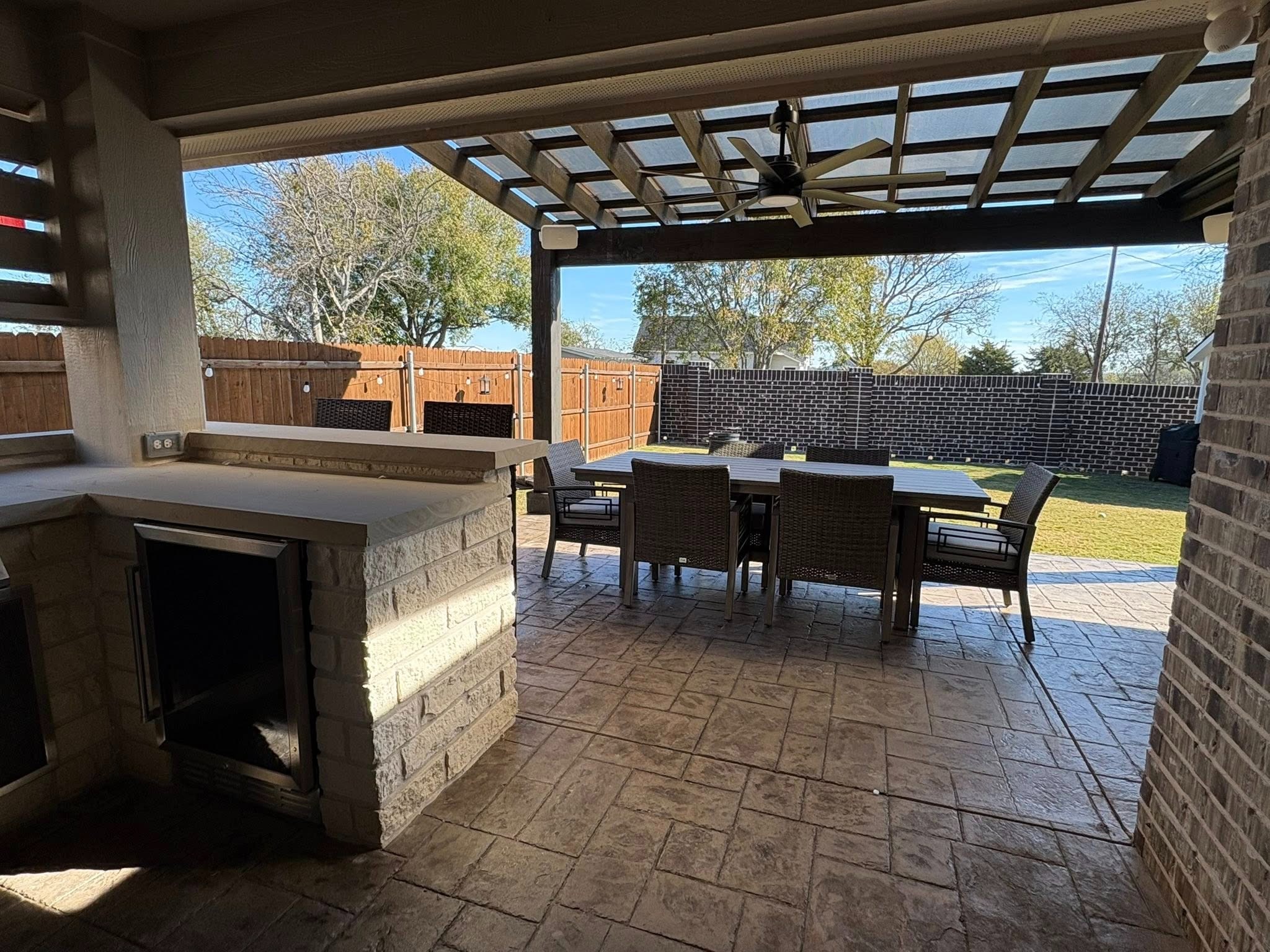 Covered patio with fireplace and dining