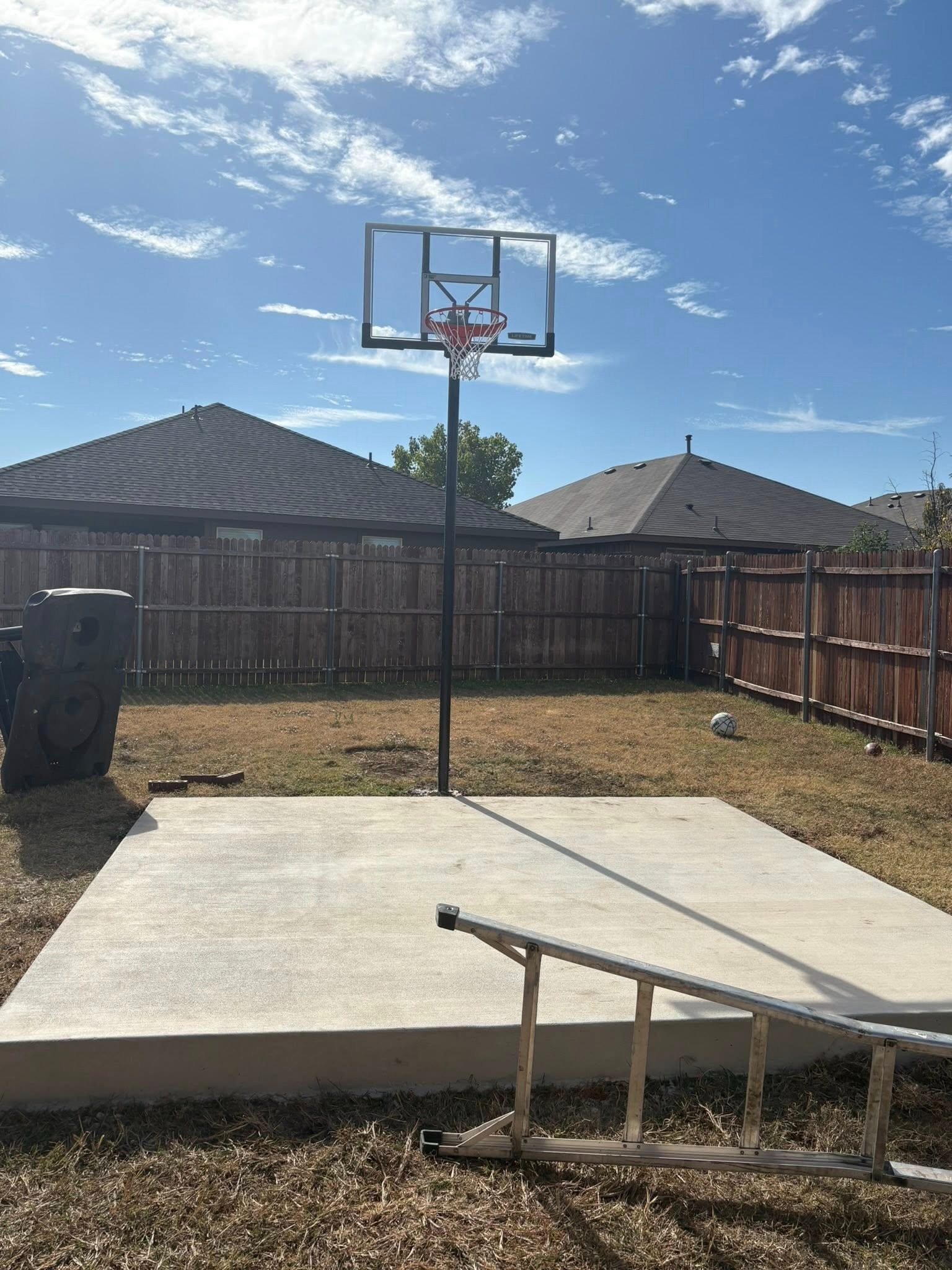 Finished concrete basketball court with hoop