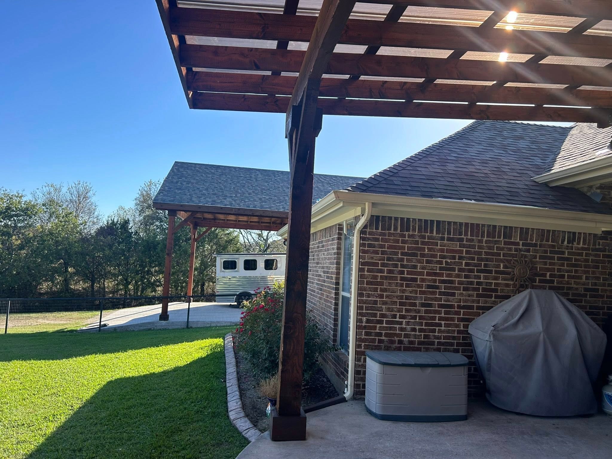 Side angle showing pergola and covered grill area