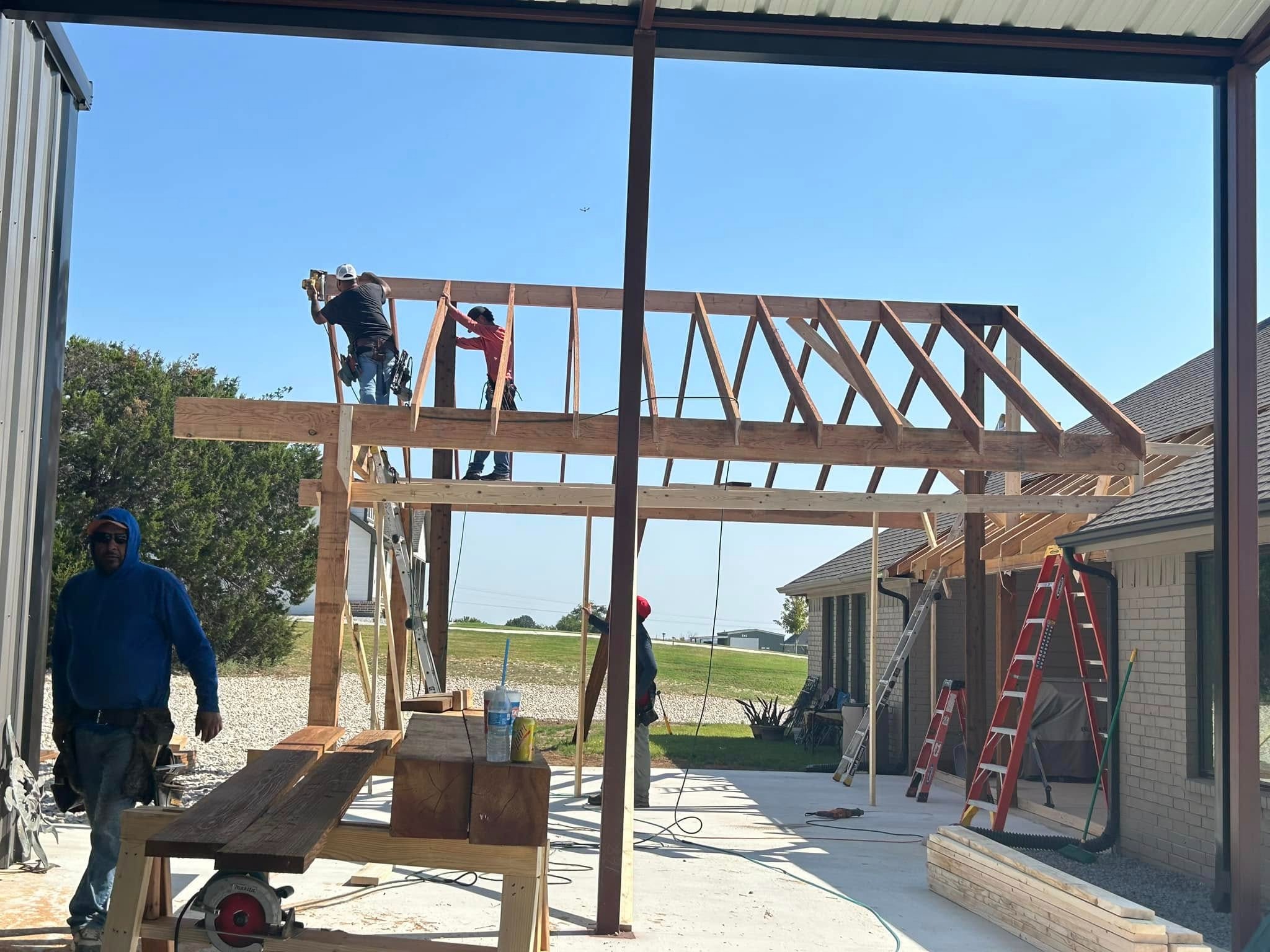 Framing in progress — crew installing roof structure