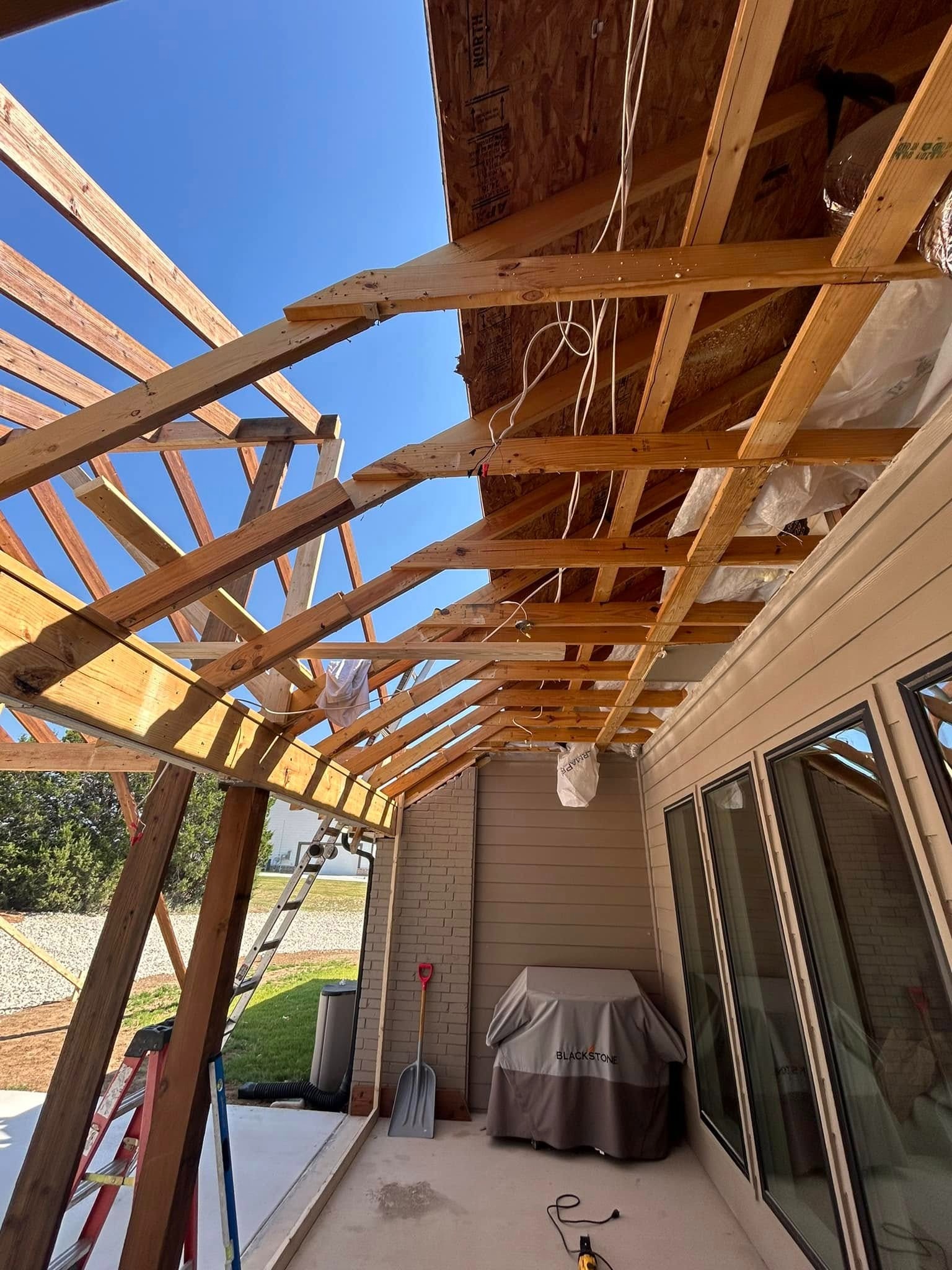 Patio roof framing on brick house