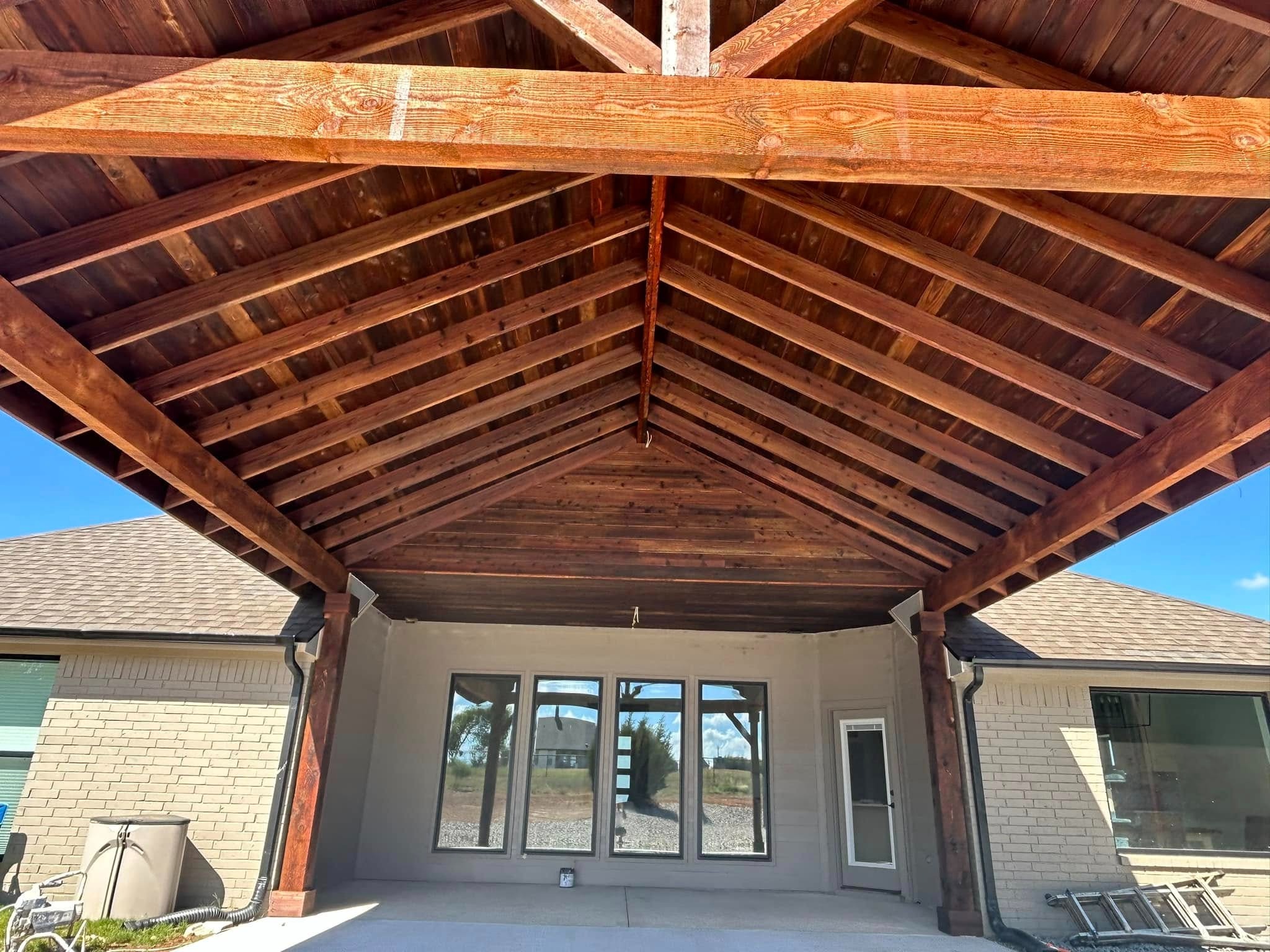 Interior — stained ceiling with trusses and glass doors